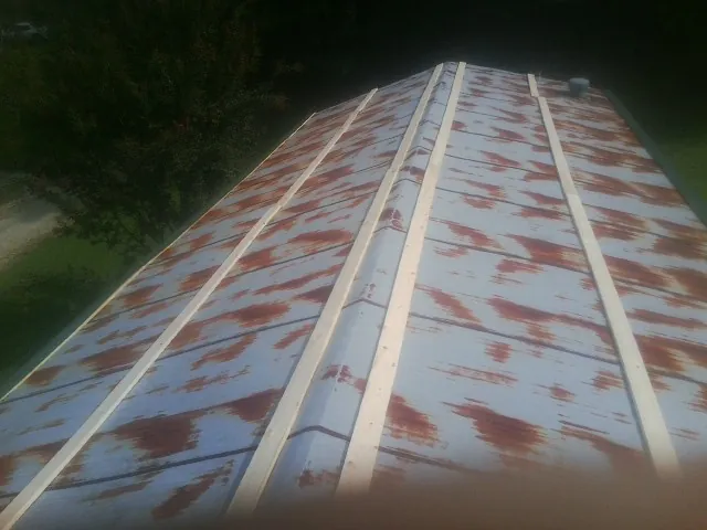Rusted metal roof panels with new wood purlins before replacement — Storm Damage Roof Repair in Fort Myer by Roofing Brothers