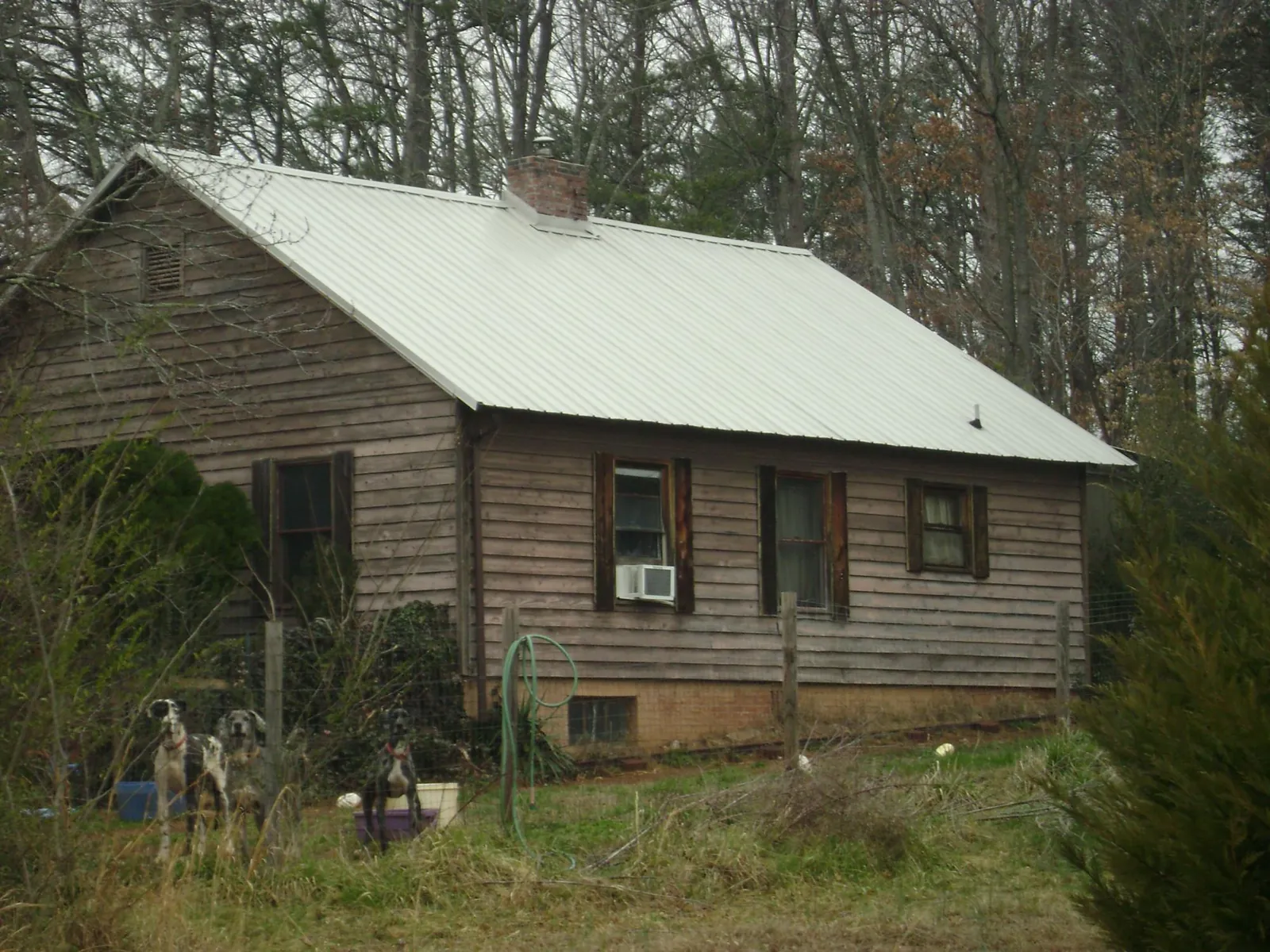 White metal roof on an old wood sided farmhouse, from a Metal Roof Installation job in Fort Myer